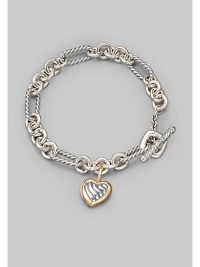 From the Cable Heart Collection. A bold chain, combining smooth and cable links, holds a lovely cable heart charm, framed in 18k gold. Sterling silver and 18k yellow gold Length, about 7½ Toggle closure Imported From the Cable Heart Collection. A bold chain, combining smooth and cable links, holds a lovely cable heart charm, framed in 18k gold. Sterling silver and 18k yellow gold Length, about 7½ Toggle closure Imported