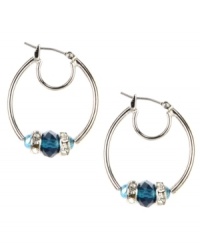 Shimmering beads lend a chic look to these classic hoops. This Nine West design highlights blue plastic beads and silver tone rondelles embellished with crystal stones. Crafted in imitation rhodium-plated mixed metal. Approximate drop: 1-1/4 inches. Approximate diameter: 1 inch. Shimmering beads lend a chic look to these classic hoops. This Nine West design highlights blue plastic beads and silver tone rondelles embellished with crystal stones. Crafted in imitation rhodium-plated mixed metal. Approximate drop: 1-1/4 inches. Approximate diameter: 1 inch.