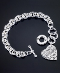 Street smart style with a beautiful twist. This GUESS bracelet is crafted in silvertone mixed metal with a stylish graffiti logo heart charm. Approximate length: 7-1/2 inches. Approximate drop: 1 inch. Street smart style with a beautiful twist. This GUESS bracelet is crafted in silvertone mixed metal with a stylish graffiti logo heart charm. Approximate length: 7-1/2 inches. Approximate drop: 1 inch.