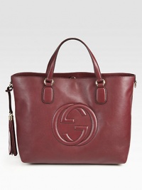 A roomy carryall crafted from rich leather with embossed interlocking G and tassels.Double top handles, 6 dropTop hook closureProtective metal feetOne inside zip pocketTwo inside open pocketsNatural cotton linen lining16W X 12H X 6DMade in Italy A roomy carryall crafted from rich leather with embossed interlocking G and tassels.Double top handles, 6 dropTop hook closureProtective metal feetOne inside zip pocketTwo inside open pocketsNatural cotton linen lining16W X 12H X 6DMade in Italy