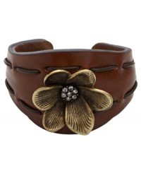 Grace your wrists with sweet florals. A combination of rich moldable leather and a brass tone floral charm with crystal accents create Fossil's stylish cuff bracelet. Tonal stitching. Set in brass tone mixed metal. Approximate diameter: 2-1/2 inches. Grace your wrists with sweet florals. A combination of rich moldable leather and a brass tone floral charm with crystal accents create Fossil's stylish cuff bracelet. Tonal stitching. Set in brass tone mixed metal. Approximate diameter: 2-1/2 inches.