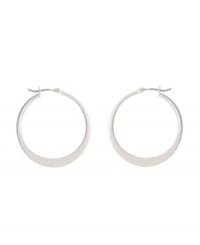 Shimmery hoops with a modern spin. Kenneth Cole New York earrings feature a graduated hoop in silver tone mixed metal. Approximate diameter: 1-1/4 inches.