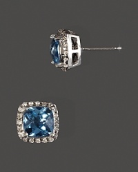 Diamonds frame faceted blue topaz, set in 14K yellow gold. Diamonds frame faceted blue topaz, set in 14K yellow gold.