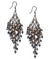 Shower your look in elegance with these chandelier earrings from c.A.K.e. by Ali Khan. Faceted glass rondelles in colorful hues are strung on metal chains for a showering effect. Crafted in hematite tone mixed metal. Approximate drop: 3 inches.