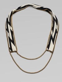 A dramatic look formed of black and white beads in a striking tribal design on a flat strap, framed and finished with bold golden chains.GlassGoldtoneCotton backingLength, about 20¾Imported A dramatic look formed of black and white beads in a striking tribal design on a flat strap, framed and finished with bold golden chains.GlassGoldtoneCotton backingLength, about 20¾Imported