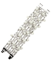 You can never have too much shine, and Givenchy's flaunt-worthy flex bracelet pulls out all the stops. Crafted in silver-plated mixed metal, bracelet is adorned with glass pearls and white glass accents. Approximate length: 7-1/4 inches.