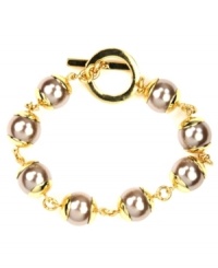 Elegance in an instant. This bracelet by AK Anne Klein features chic plastic pearl beads and toggle clasp. Crafted in gold tone mixed metal. Approximate length: 7-3/4 inches. Elegance in an instant. This bracelet by AK Anne Klein features chic plastic pearl beads and toggle clasp. Crafted in gold tone mixed metal. Approximate length: 7-3/4 inches.