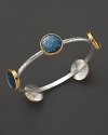 A bold sterling silver bangle from Gurhan with Paua shell stations in 24K yellow gold.
