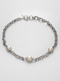 Three beautiful pearl stations on a rhodium-plated stainless steel chain link design. 14mm-16mm organic white baroque man-made pearlRhodium-plated stainless steelLength, about 17Toggle closureImported Three beautiful pearl stations on a rhodium-plated stainless steel chain link design. 14mm-16mm organic white baroque man-made pearlRhodium-plated stainless steelLength, about 17Toggle closureImported