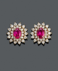 Indulge in the ultimate pair of red ruby stud earrings. From Royalty Inspired by Effy Collection, these stunning earrings feature oval-cut ruby (2 ct. t.w.) surrounded by glistening petals of round-cut diamond (1-1/4 ct. t.w.). Approximate diameter: 5/8 inch. Indulge in the ultimate pair of red ruby stud earrings. From Royalty Inspired by Effy Collection, these stunning earrings feature oval-cut ruby (2 ct. t.w.) surrounded by glistening petals of round-cut diamond (1-1/4 ct. t.w.). Approximate diameter: 5/8 inch.