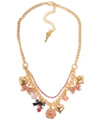 Clusters of charms. Betsey Johnson's antique gold tone mixed metal necklace features a gold-tone rose, bows with ombre pave crystal accents, gold-tone bubble hearts, a hematite-plated bow with pink crystal accent, and pink faceted beads all on a gold-tone necklace chain with pink crystal cup chain accents. Approximate length: 16 inches + 3-inch extender. Approximate drop: 1-1/2 inches. Clusters of charms. Betsey Johnson's antique gold tone mixed metal necklace features a gold-tone rose, bows with ombre pave crystal accents, gold-tone bubble hearts, a hematite-plated bow with pink crystal accent, and pink faceted beads all on a gold-tone necklace chain with pink crystal cup chain accents. Approximate length: 16 inches + 3-inch extender. Approximate drop: 1-1/2 inches.