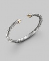 From the Cable Classics Collection. The essence of Yurman style in a simple, slender cable bangle, capped with domes of 14k gold. Sterling silver and 14k yellow gold Cable, 5mm Diameter, about 2¼ Imported