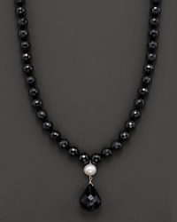 A dramatic black onyx and fresh water pearl necklace with faceted teardrop onyx centerpiece. A dramatic black onyx and fresh water pearl necklace with faceted teardrop onyx centerpiece.