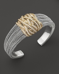 Diamonds in 18K yellow gold wrap around this sterling silver statement cuff from Lagos. Diamonds in 18K yellow gold wrap around this sterling silver statement cuff from Lagos.