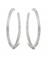 Stellar style fit for a celebrity. This elegant pair of silver tone mixed metal hoop earrings sparkles in clear Swarovski crystal pavé and reflects the light in a thousand facets. These unique earrings add a touch of sophistication to your look. Approximate diameter: 1-7/8 inches.