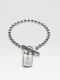 A sterling silver ball chain holds a classic dog tag charm engraved with the Gucci crest and a bold toggle clasp. Sterling silver Length, about 7¼ Charm, about ¾L X ½W Toggle clasp Made in Italy A sterling silver ball chain holds a classic dog tag charm engraved with the Gucci crest and a bold toggle clasp. Sterling silver Length, about 7¼ Charm, about ¾L X ½W Toggle clasp Made in Italy