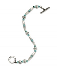 A serene touch of blue blends wonderfully with industrial silver on this Lauren by Ralph Lauren toggle bracelet. Crafted with antiqued silver tone mixed metal with reconstituted turquoise beads accents. Approximate length: 7-1/2 inches. A serene touch of blue blends wonderfully with industrial silver on this Lauren by Ralph Lauren toggle bracelet. Crafted with antiqued silver tone mixed metal with reconstituted turquoise beads accents. Approximate length: 7-1/2 inches.