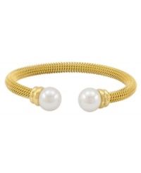 Lovely and lustrous. Organic man-made pearls adorn this beautiful bangle bracelet from Majorica. Crafted in gold tone stainless steel, it's a chic complement for your workday wardrobe. Approximate diameter: 2-1/2 inches. Lovely and lustrous. Organic man-made pearls adorn this beautiful bangle bracelet from Majorica. Crafted in gold tone stainless steel, it's a chic complement for your workday wardrobe. Approximate diameter: 2-1/2 inches.