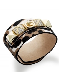This edgy cuff bracelet from Juicy Couture features a gold tone brass plaque with a crown logo and pyramid studs embellished with glass stones. Crafted from printed calf hair leather. Approximate length: 9 inches. Approximate diameter: 2 inches. This edgy cuff bracelet from Juicy Couture features a gold tone brass plaque with a crown logo and pyramid studs embellished with glass stones. Crafted from printed calf hair leather. Approximate length: 9 inches. Approximate diameter: 2 inches.