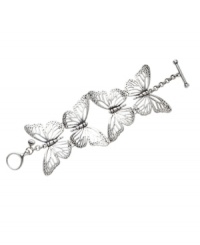 Let your natural side take flight. Fossil's whimsical bracelet features four, cut-out butterflies set in silver tone mixed metal with a toggle clasp and crystal details. Approximate length: 7-1/2 inches.