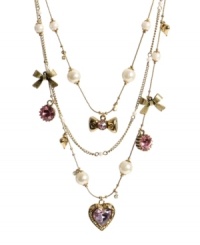 In the mood for love? Show it in Betsey Johnson's sweet styles. This illusion-style necklace features three layers of pink crystal hearts, glass pearls, and shiny bows. Setting and chains crafted in antique gold tone mixed metal. Approximate length: 15-1/2 inches + 3-inch extender. In the mood for love? Show it in Betsey Johnson's sweet styles. This illusion-style necklace features three layers of pink crystal hearts, glass pearls, and shiny bows. Setting and chains crafted in antique gold tone mixed metal. Approximate length: 15-1/2 inches + 3-inch extender.