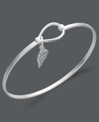 All you need in life is love. This inspirational bangle features a loop and hook design and a dangling heart-shaped charm engraved with the word Love. Crafted in sterling silver. Approximate diameter: 2-1/2 inches. Approximate charm size: 1/3 inch.