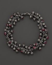 Inspired by Zen philosophy, this intricately detailed sterling silver bracelet from Paul Morelli softly jingles with meditation bells and cabochons of pink rhodalite. Inspired by Zen philosophy, this intricately detailed sterling silver bracelet from Paul Morelli softly jingles with meditation bells and cabochons of pink rhodalite.