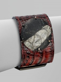 A beautiful contrast of textures and colors with this natural, statement piece featuring a fossil in smooth stone. Orthoceras fossil in stoneBrassCroc embossed leatherLength, about 1¾ to 2½ adjustableBuckle closureMade in USAPlease note: Stone size and appearance may vary. A beautiful contrast of textures and colors with this natural, statement piece featuring a fossil in smooth stone. Orthoceras fossil in stoneBrassCroc embossed leatherLength, about 1¾ to 2½ adjustableBuckle closureMade in USAPlease note: Stone size and appearance may vary.