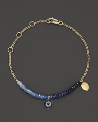 Adorn yourself with sparkling diamonds and rough-cut sapphire briolettes set in a 14K yellow gold bracelet inspired by ancient traditions. Adorn yourself with sparkling diamonds and rough-cut sapphire briolettes set in a 14K yellow gold bracelet inspired by ancient traditions.