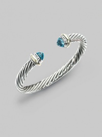 From the Silver Classics Collection. The signature Yurman cable bangle, capped with faceted blue topaz domes and accents of 14k gold. Blue topaz Sterling silver and 14k yellow gold Cable, 7mm Diameter, about 2¼ Imported From the Silver Classics Collection. The signature Yurman cable bangle, capped with faceted blue topaz domes and accents of 14k gold. Blue topaz Sterling silver and 14k yellow gold Cable, 7mm Diameter, about 2¼ Imported