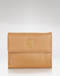 Poised and practical. Tory Burch offers unbeatable understated style with this leather wallet, accented by a subtle logo plaque. Poised and practical. Tory Burch offers unbeatable understated style with this leather wallet, accented by a subtle logo plaque.