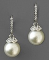 Dress up with old-world glamour. These Givenchy glass pearl earrings feature crystal accents set in silvertone mixed metal. Approximate drop: 1-1/2 inches.