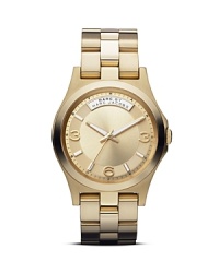 A cool logo plaque details this MARC BY MARC JACOBS watch, which is classically styled in plated metal and set on a matching bracelet. A cool logo plaque details this MARC BY MARC JACOBS watch, which is classically styled in plated metal and set on a matching bracelet.