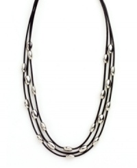 Let sleek beads add extra polish to your look. Nine West's chic three row necklace features leather cords strung with oval-shaped beads in silver tone mixed metal. Approximate length: 16 inches. Let sleek beads add extra polish to your look. Nine West's chic three row necklace features leather cords strung with oval-shaped beads in silver tone mixed metal. Approximate length: 16 inches.