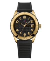 Bring drama to the game with this bold and durable watch by Tommy Hilfiger. Ribbed black silicone strap and round gold ion-plated stainless steel case. Gold tone and black bezel etched with numerals. Logo-embossed black dial features applied gold tone numerals, minute track, three hands and flag logo. Quartz movement. Water resistant to 30 meters. Ten-year limited warranty. Bring drama to the game with this bold and durable watch by Tommy Hilfiger. Ribbed black silicone strap and round gold ion-plated stainless steel case. Gold tone and black bezel etched with numerals. Logo-embossed black dial features applied gold tone numerals, minute track, three hands and flag logo. Quartz movement. Water resistant to 30 meters. Ten-year limited warranty.