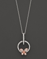A dainty diamond butterfly pendant set in 14K. rose and white gold. A dainty diamond butterfly pendant set in 14K. rose and white gold.