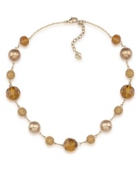 Golden rules. Gold-hued glass pearls are complemented by alluring amber-colored fireball accents on Carolee's chic illusion necklace. Made in gold tone mixed metal, it will add polish to your workday wardrobe. Approximate length: 16 inches + 2-inch extender.