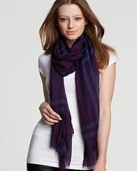 A large, sheer oblong scarf featuring a bright violet check pattern from Burberry. A large, sheer oblong scarf featuring a bright violet check pattern from Burberry.