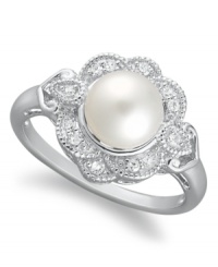 A fine display of poise and sophistication, this elegant cultured freshwater pearl ring (7 mm) presents a touch of vintage flair with the addition of diamond-studded (1/10 ct. t.w.) petals. Crafted in sterling silver. Size 7. A fine display of poise and sophistication, this elegant cultured freshwater pearl ring (7 mm) presents a touch of vintage flair with the addition of diamond-studded (1/10 ct. t.w.) petals. Crafted in sterling silver. Size 7.