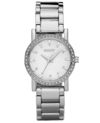 DKNY creates a dreamy watch with a mother-of-pearl dial and sparkling crystal accents at the bezel. Stainless steel bracelet and round case. Dial features stick indices and logo. Quartz movement. Water resistant to 50 meters. Two-year limited warranty. DKNY creates a dreamy watch with a mother-of-pearl dial and sparkling crystal accents at the bezel. Stainless steel bracelet and round case. Dial features stick indices and logo. Quartz movement. Water resistant to 50 meters. Two-year limited warranty.