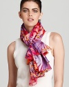 A vibrant tropical forest decorate this sheer oblong scarf from Salvatore Ferragamo.