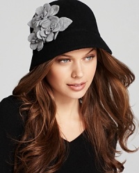 Textured gray flowers pop off the black background of this enchanting August Accessories cloche. Textured gray flowers pop off the black background of this enchanting August Accessories cloche.