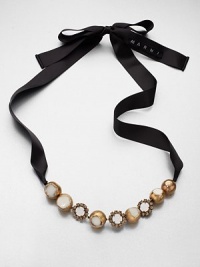 A unique piece on satin ribbon that features sparkling glass stones and glossy, resin accented metal ball links. GlassResinPolyesterBrassLength, about 19.7Tie closureImported A unique piece on satin ribbon that features sparkling glass stones and glossy, resin accented metal ball links. GlassResinPolyesterBrassLength, about 19.7Tie closureImported