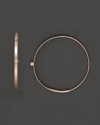 A graceful hoop in yellow gold with diamond accent and invisible closure to create a perfectly elegant orb to complement your most refined ensembles. Designed by Lana. A graceful hoop in yellow gold with diamond accent and invisible closure to create a perfectly elegant orb to complement your most refined ensembles. Designed by Lana.