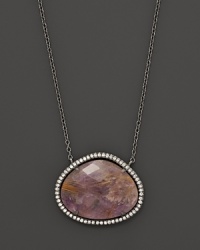 Diamonds circle a faceted rutilated quartz and purple charoite doublet set in blackened sterling silver. By Di Massima. Diamonds circle a faceted rutilated quartz and purple charoite doublet set in blackened sterling silver. By Di Massima.
