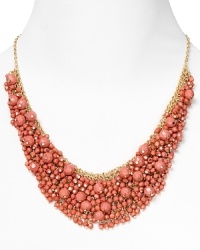 Brighten up every outfit with this layered beaded bib necklace from Cara accented by a dramatic collar of coral stones. Brighten up every outfit with this layered beaded bib necklace from Cara accented by a dramatic collar of coral stones.