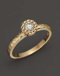 Faceted diamond set in a textured 14K. yellow gold band. Faceted diamond set in a textured 14K. yellow gold band.