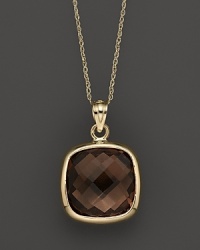 A bold, faceted smoky quartz glitters in a 14K yellow gold setting. A bold, faceted smoky quartz glitters in a 14K yellow gold setting.