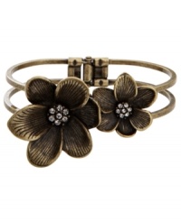 Vintage inspiration. Two flowers with sparkling crystal centers create an earthy illusion on Fossil's pretty bangle bracelet. Set in brass tone mixed metal with a hinge clasp. Approximate diameter: 2-1/2 inches. Vintage inspiration. Two flowers with sparkling crystal centers create an earthy illusion on Fossil's pretty bangle bracelet. Set in brass tone mixed metal with a hinge clasp. Approximate diameter: 2-1/2 inches.
