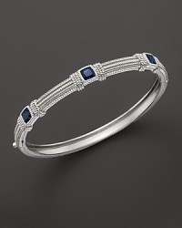 Blue corundum cushion stones decorative a timeless sterling silver bangle from Judith Ripka. Blue corundum cushion stones decorative a timeless sterling silver bangle from Judith Ripka.